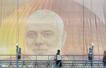 FILE: Iranian workers install a huge banner on a wall showing a portrait of Hamas leader Ismail Haniyeh in Tehran, 31 July 2024