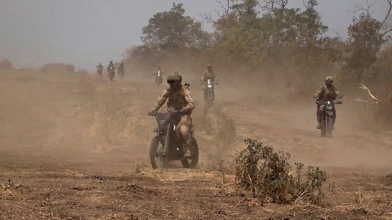 In this photo taken from video released by Russian Defense Ministry Press Service on Monday, Aug. 12, 2024, marine assault team members ride motorcycles.