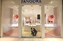 Tania Lima unlocks the glass doors opening a Pandora retail store in the Galleria Dallas mall in Dallas, Monday, May 4, 2020. 