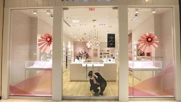 Tania Lima unlocks the glass doors opening a Pandora retail store in the Galleria Dallas mall in Dallas, Monday, May 4, 2020. 