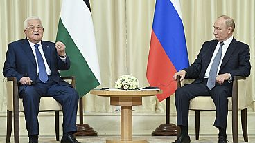 Palestinian President Mahmoud Abbas, left, and Russian President Vladimir Putin walk after their meeting at Novo-Ogaryovo state residence outside Moscow, Russia, Tuesday, Aug.