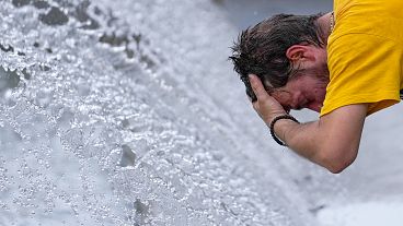 FILE: A man cools off at a fountain during a sunny day in Belgrade, 13 July 2023