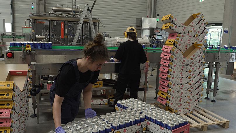 Fuerst Wiacek employees preparing beer cans for shipping