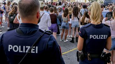 Police officers stand near gathering swifties in Vienna on Friday, Aug.9, 2024.