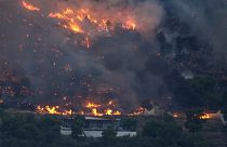 Fire approaches houses in Kalamaki near Agioi Theodori about 60 Kilometres west of Athens.