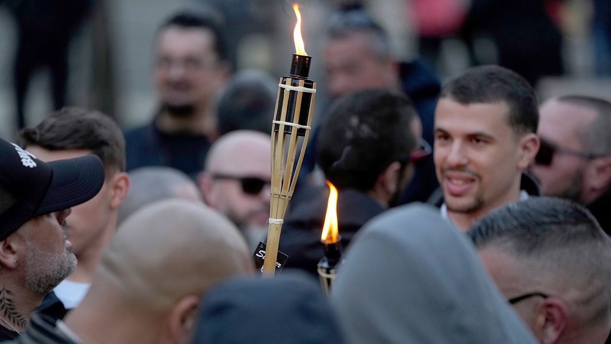 FILE: Supporters of the Portuguese nationalist movement 1143 light torches before staging a protest march under the slogan "Stop Islam" in downtown Lisbon, 3 February 2024