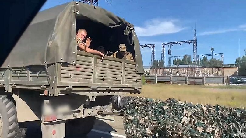 Russian soldiers in a column moving towards Ukraine's soldiers in the Sudzhansk district of Kursk 