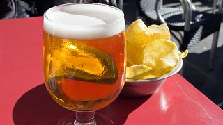 Beer and crisps on a terrace table.