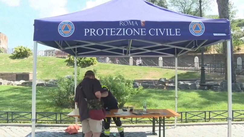 Rome's Civil Protection agencies hands out water bottles to citizens.