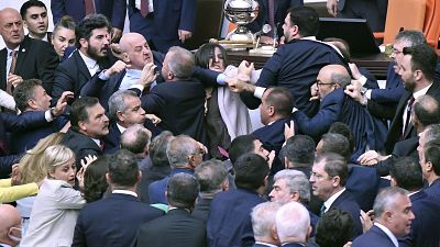 Lawmakers scuffle during an extraordinary session of the Turkish Grand National Assembly to debate the case of jailed opposition lawmaker Can Atalay, August 16, 2024