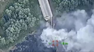 In this photo provided by the Ukrainian Defence Ministry Press Office, a strategically important bridge over the river Seym is destroyed by Ukrainian troops.