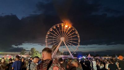 Gondolas on a Ferris wheel at Leipzig's Highfield Festival are shown burning, August 18, 2024