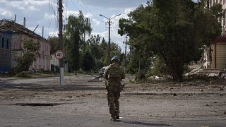 A Ukrainian soldier walks in the city centre of Sudzha, August 16, 2024