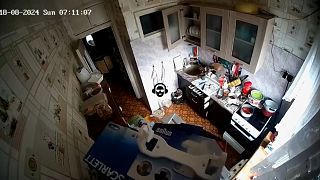 CCTV footage of kitchen in an apartment shaking during earthquake