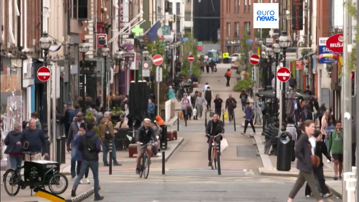 People cycling down a busy street in Dublin, Ireland. 