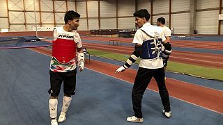 Member of the Refugee Paralympic Team Hadi Hassanzada, left, who will compete in Para taekwondo, trains ahead of the Paralympic Games, Monday, Aug. 19, 2024