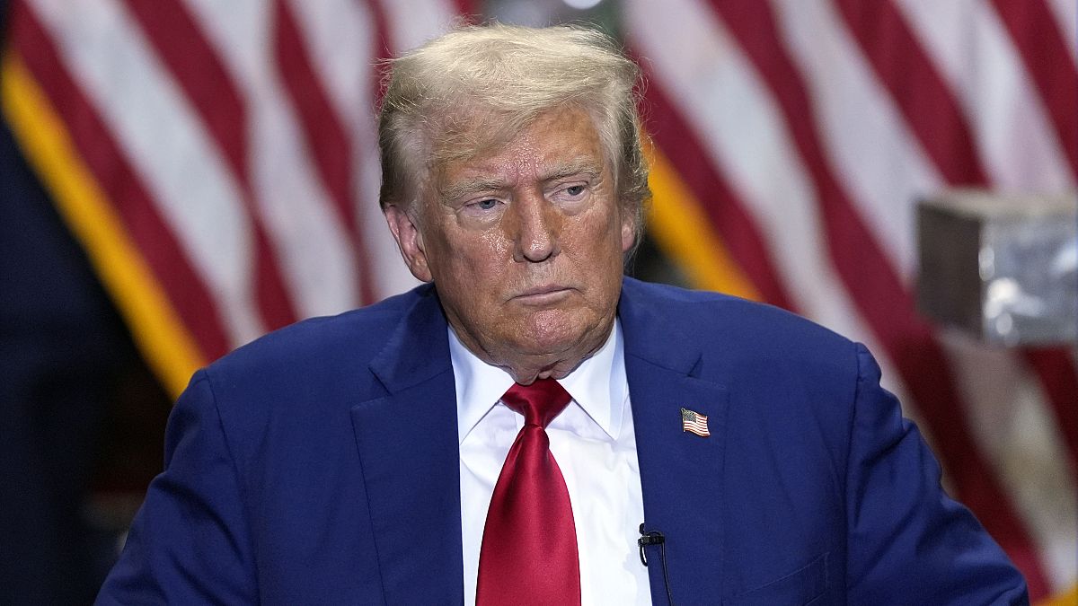 Republican presidential nominee former President Donald Trump listens at a business roundtable discussion at a campaign event at Precision Components Group