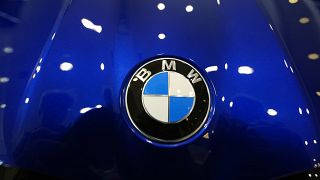 The company logo shines on the hood of an unsold vehicle at a Mini Honda BMW dealership on July 22, 2024, in Highlands Ranch.