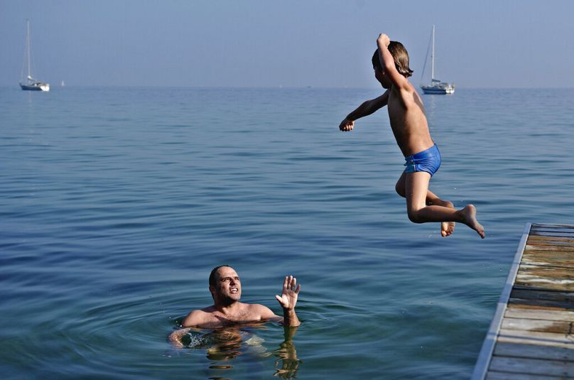 Carsten Vammen and Sebastian enjoying the warm weather at Bellevue Beach north of Copenhagen on Saturday, Oct 1, 2011.