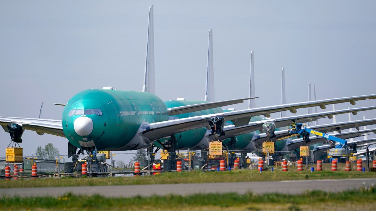 A line of Boeing 777X jets are parked nose to tail on an unused runway at Paine Field, near Boeing's massive production facility, Friday, April 23, 2021, in Everett, Wash. 