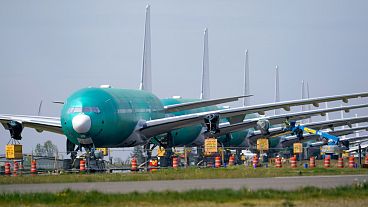 A line of Boeing 777X jets are parked nose to tail on an unused runway at Paine Field, near Boeing's massive production facility, Friday, April 23, 2021, in Everett, Wash. 