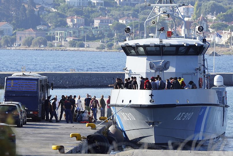 Migrants disembark from a Greek coast vessel in Lesbos after a rescue operation, 28 August, 2023