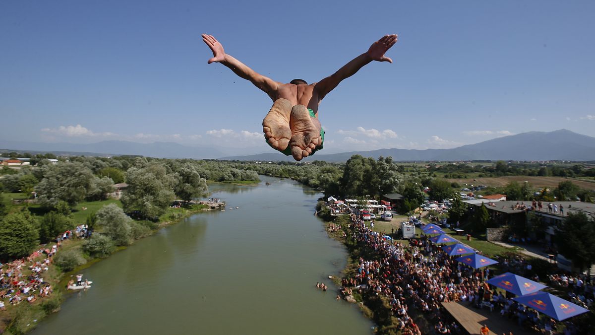 Daredevils jump from historic Kosovo bridge in 74th annual high diving competition