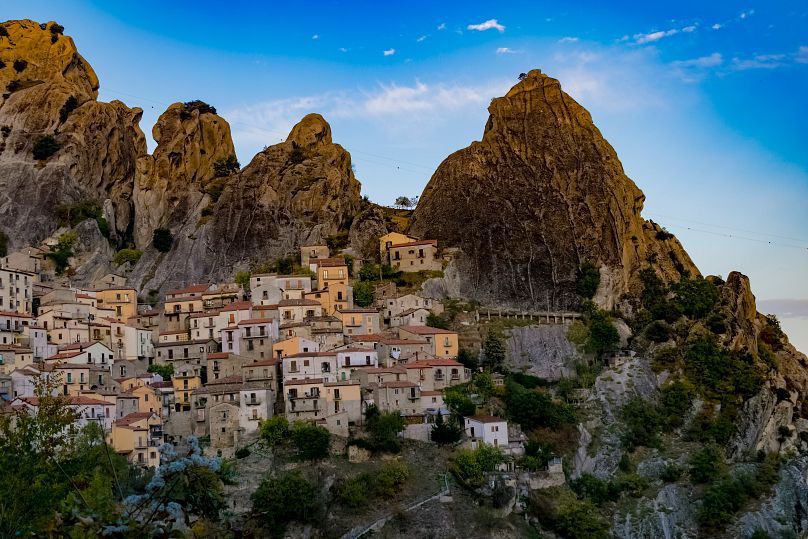 the village of Castelmezzano clings to giant shards of grey rock rising above the treeline. 