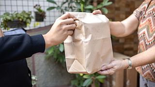 A person collects their food delivery.