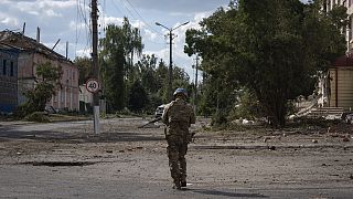 A Ukrainian soldier walks past at a city centre in Sudzha, Kursk region, Russia, Friday, Aug. 16, 2024. 