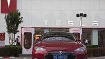 A Tesla vehicle is parked outside a showroom in Beijing, China, Tuesday, May 22, 2018. 