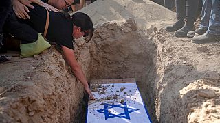 Rimon Buchshtab mourns during the funeral of her husband Yagev Buchshtab at a cemetery of the Kibbutz Nirim, southern Israel, Wednesday, Aug. 21, 2024.