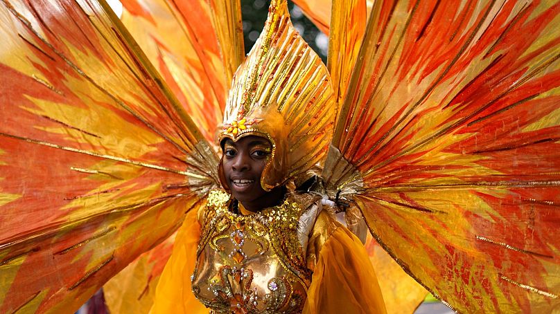 A participant in colourful costume at Notting Hill Carnival, 2023