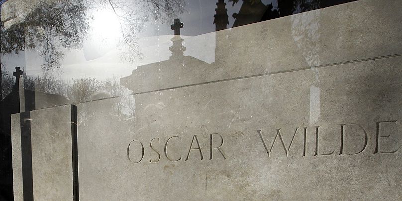 The glass barrier surrounding Oscar Wilde's grave at Père Lachaise Cemetery in Paris