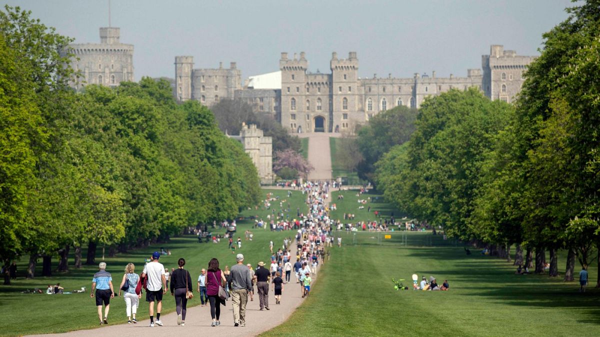 People walk along the Long Walk heading up to Windsor Castle in Windsor, April 2019.