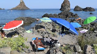 Holidaymakers at the beach in Aci Trezza, near Catania in Sicily 