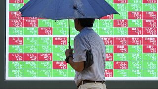 FILE - A person looks at an electronic stock board showing Japan's Nikkei index at a securities firm in Tokyo, on July 12, 2024.