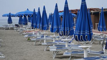 Umbrellas and sun beds are set at the Venezia beach establishment in Ostia, near Rome. 16 August, 2024.