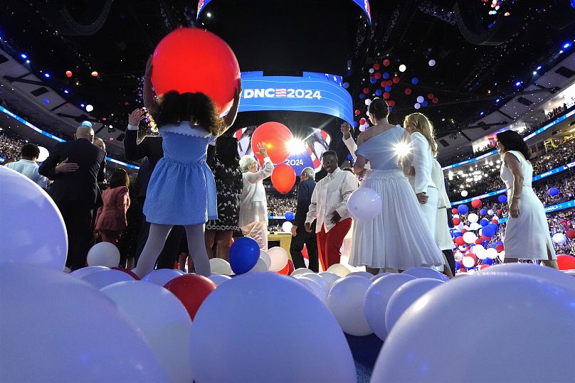 Democratic presidential nominee Kamala Harris, second gentleman Doug Emhoff, Tim Walz and his wife Gwen Walz on stage on the last night of the DNC