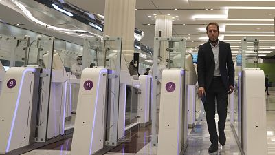 A man goes through an automated gate at Dubai Airport, in the United Arab Emirates, Sunday March 7, 2021. 