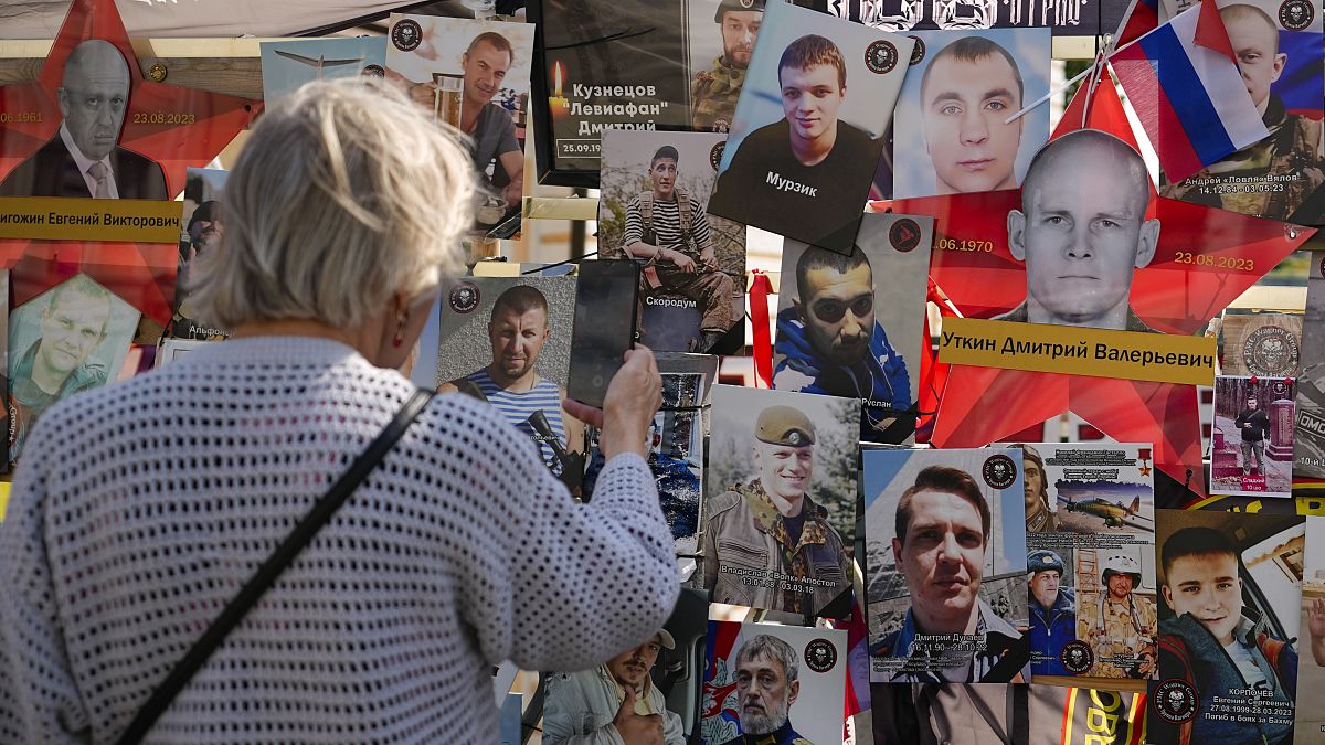 People stand near an improvised memorial to Wagner mercenary chief Yevgeny Prigozhin who died in a plane crash exactly one year ago, in Moscow, Russia, Friday, Aug. 23, 2024.