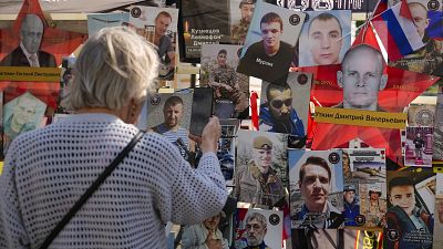 People stand near an improvised memorial to Wagner mercenary chief Yevgeny Prigozhin who died in a plane crash exactly one year ago, in Moscow, Russia, Friday, Aug. 23, 2024.