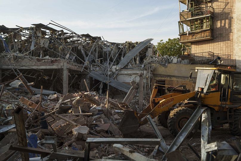 A firefighter collects fragments of a rocket after a Russian strike on Sapphire Hotel in Kramatorsk, August 25, 2024