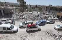 FILE: People inspect their destroyed houses that were hit by an Israeli airstrike, in Aita al-Shaab village, south Lebanon, 29 June 2024