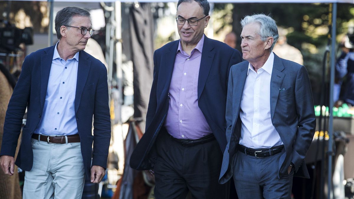 Governor of the Bank of Canada Tiff Macklem, left, and Governor of the Bank of England Andrew Bailey, center, walk with Federal Reserve Chairman Jerome Powell at Jackson Hole