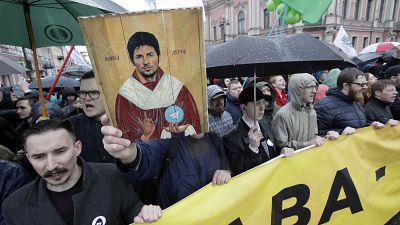 Protesters hold a portrait of messaging app Telegram co-founder Pavel Durov, 2018.