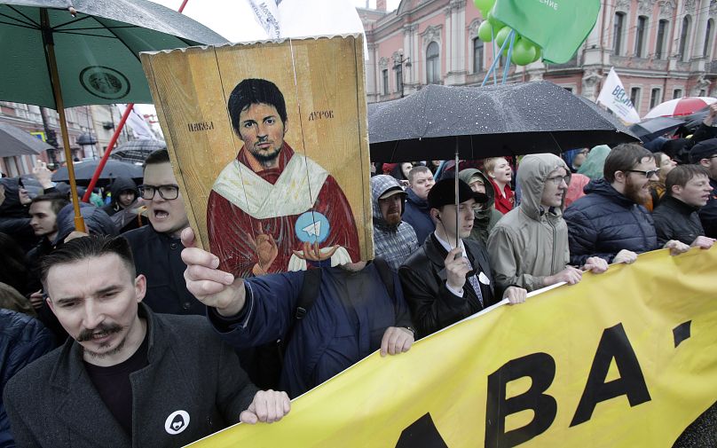 Protesters hold a portrait of messaging app Telegram co-founder Pavel Durov designed as an icon, protesting against the blocking of the app in Russia, during a May Day rally i