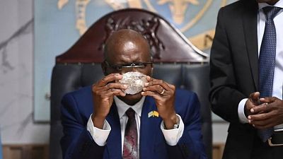 Botswana's President Mokgweetsi Masisi holds the 2,492-carat diamond that was unearthed at one of its mines