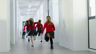 Primary school students running to class