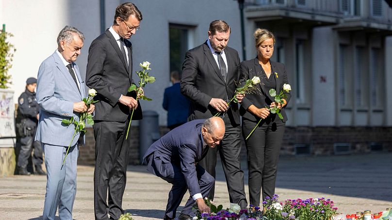 German Chancellor Olaf Scholz lays flowers, near the scene of a knife attack in Solingen, Germany, Monday, Aug. 26, 2024.